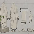 Soft Towels And Cozy Robes Arranged With Slippers On Gray Tiled Wall