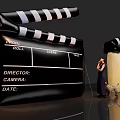 Art Installation Featuring Giant Clapperboard Miniature Figure And Dog Design Elements