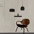 Modern Pendant Lights With Transparent Glass Shades And Black Metal Frames Near Wooden Chair