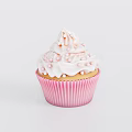 Freshly Baked Delicious Cupcake with Pink Paper Wrapper White Swirl Frosting and Tiny Pink Sprinkles