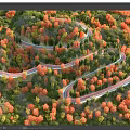 Winding Road Through Colorful Autumn Forest With Lush Trees