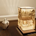 Traditional Chinese Style Table Lamp With Ink Painting Shade And Ceramic Vase On Wooden Table