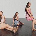 Three Women Sitting On The Floor Smiling Wearing Different Dresses And Shorts