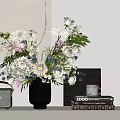 Beautiful Flower Arrangement In Black Vase With Books And Photo Frame
