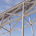 Steel Truss Bridge Structure With Metal Frame Under Clear Blue Sky