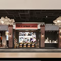 Shopping Mall Lobby With Striped Awning Brick Walls And White Spherical Pendant Lights