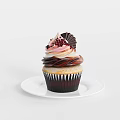 Delicious Cupcake with Swirls of Pink and White Cream and Chocolate Decorations on White Plate