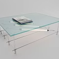 Glass Coffee Table with Transparent Top and Metal Frame Featuring a Book on Surface