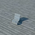 White Outdoor Chair Placed On Gray Wooden Floor With Shadow