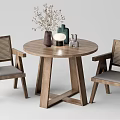 Wooden Round Table And Rattan Back Gray Cushioned Chairs With Decorative Vases