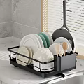 Black Kitchen Dish Rack With Plates Bowls Spoons Near Sink On Marble Countertop