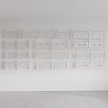 White Decorative Shelves Arranged on Wall With Various Designs and Patterns