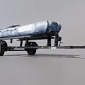 Wooden Boat With Blue And White Camouflage Pattern On Trailer With Black Wheels And Hitch