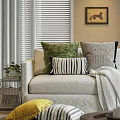 Cozy Couch Pillows in Green Black White Stripes and Geometric Patterns on Beige Sofa