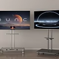 Modern Televisions on Wheeled Metal Stands with Dune and Futuristic Screen Visuals