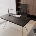 Modern Desk with Black Tabletop Metal Legs Lamp Open Book Gray Chair and Wooden Bookshelf