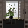 Ceramic Vase With Natural Branches And Green Foliage On Round Metal Table With Wooden Shutters