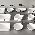 Various Shaped White Washbasins With Black Faucets On Grey Countertop