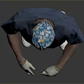 Male Medical Professional In Blue Surgical Scrubs With Cap Mask And Gloves