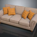 Beige Three Seat Sofa with Orange Geometric Pattern Cushions Nailhead Trim and Wooden Legs