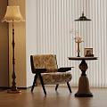 Floral Fabric Accent Chair with Black Legs by Round Table Vase and Floor Lamp