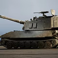 Sandy Colored Military Tank With Long Cannon And Top Mounted Equipment In Outdoor Setting