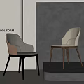 Modern Dining Chairs With Fabric Upholstery And Wood Legs Showcased Against Gray Wall