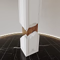 White Carved Sculpture with Broken Middle Revealing Brown Interior on Black Marble Floor and Lighting