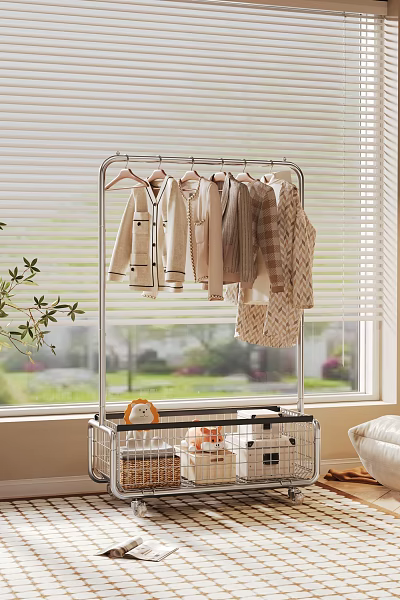 Metal Clothes Rack Holding Light Colored Clothes With Storage Basket And Plant By Window 3d model