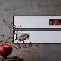Gray Wall Interior With Black Framed Artworks Red Vase And Berry Branches