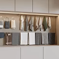 Various Color Soft Towels Hanging And Folded In Wooden Bathroom Cabinet With Hooks