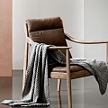 Brown Leather Leisure Chair With Wooden Armrests And Gray Blanket In Modern Interior