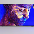 4K HDR TV Displaying Vivid Colorful Particle Face on Blue Screen