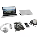Open Apple Laptop Displaying Scenic View With Headphones Phone Magazine And Coffee