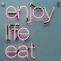 Stylish Decorative Neon Lights Spell Life Eat Cake On Light Blue Background