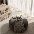 Gray Footstool with Striped Scarf and Luggage Cases on Wooden Floor