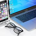 Modern Laptop Setup With Smartphone Headphones External Hard Drive And Charging Cable