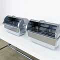 Restaurant Buffet Setup With Two Stainless Steel Food Warmers On White Table
