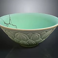 Carved Ceramic Bowl With Intricate Lotus Patterns Light Green Glaze and Visible Edge Crack