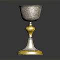 Artisan Crafted Silver Goblet With Intricate Carved Patterns And Golden Base