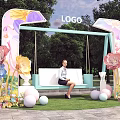 Vibrant Photo Check in Spot With Swing Bench Colorful Flowers And Ball Decor On Grass
