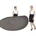 Two Women In White Blouses And Black Skirts Standing By Large Oval Object