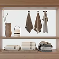 Hanging And Folded Towels Displayed On Wooden Shelf With Home Decor Items