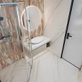 Modern Bathroom Interior With Marble Textured Wall Round Mirror Glass Shower And Vanity Lighting