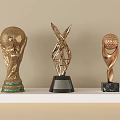 Golden Trophies With Football Golf Ball And Metal Structure Designs On White Shelf
