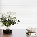 Transparent Vase with White Flowers Green Leaves on Wooden Table White Blinds Interior Decor