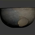 Ancient Sculpted Bowl Featuring Intricate Decorative Patterns And Bronze Patina