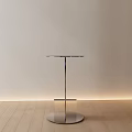 Contemporary Round Accent Table with Polished Metal Frame and Clear Glass Top in Stylish Interior
