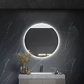 Circular Backlit Mirror On Dark Marble Wall With Bathroom Sink And Dried Plants