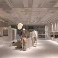 Light Colored Clothing Store Interior With Clothes Racks Display Shelves And Soft Lighting